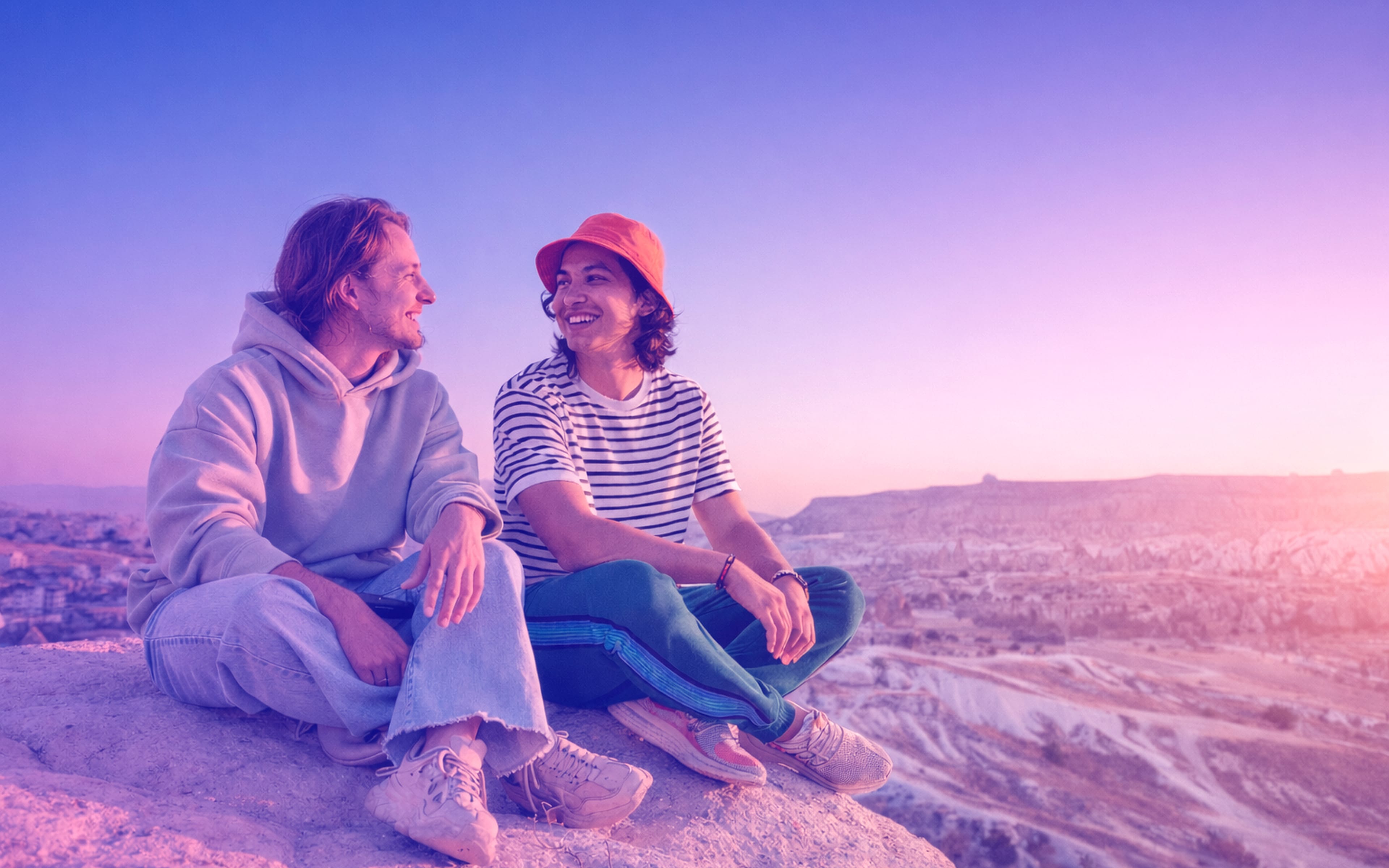 Two male friends sitting outdoor and talking