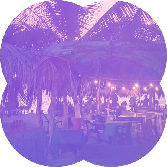 Beach bar with palm trees at sunset